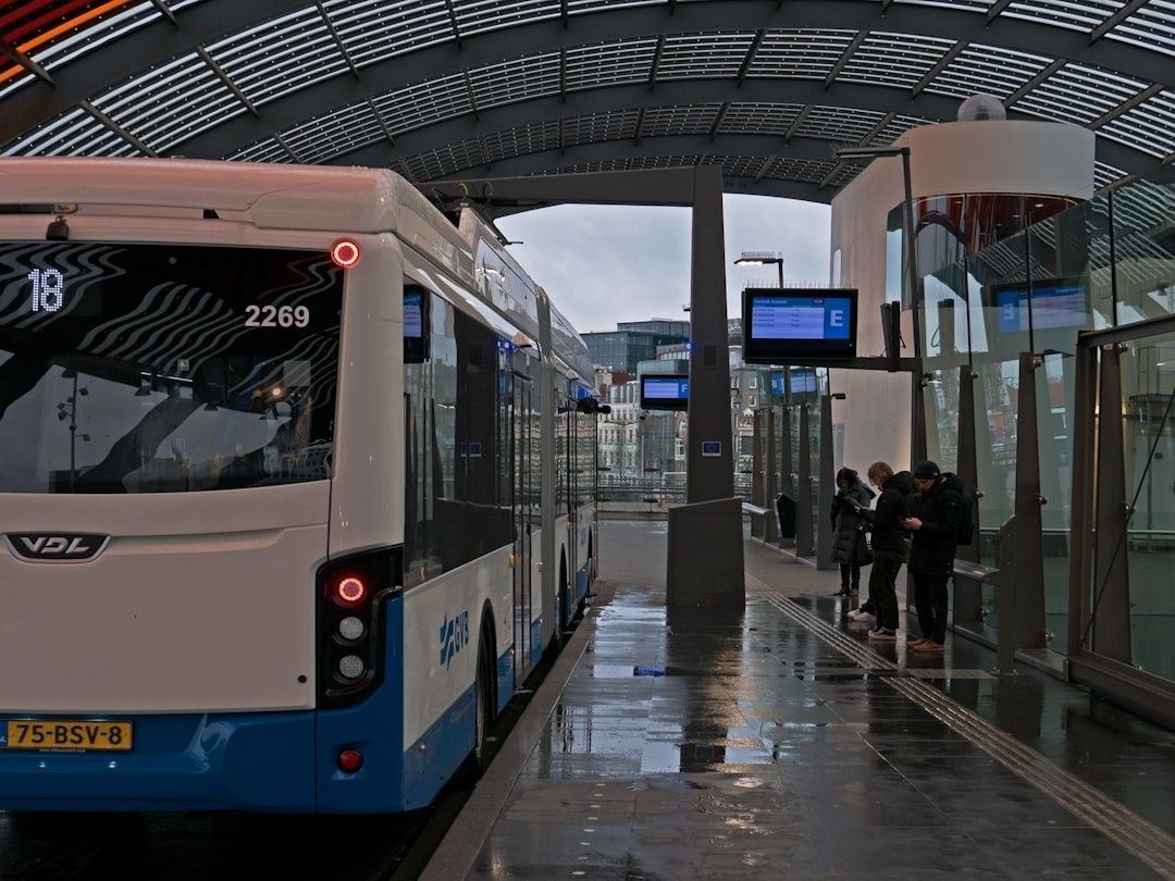 Articulated city bus stopped at a covered station platform